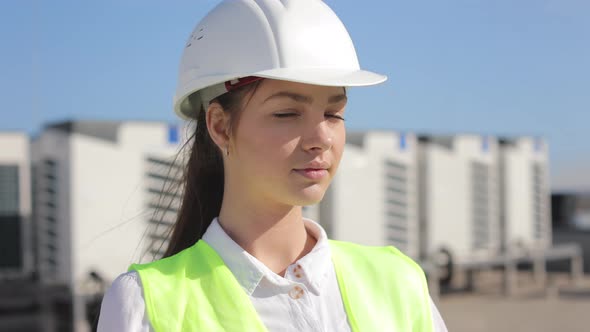 Portrait of a Happy Woman Engineer is Looking at the Camera alt