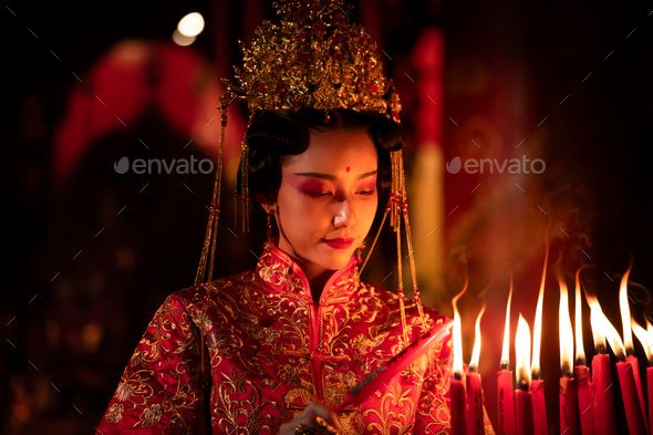 Chinese woman make wishes, pray, and light candles. - Stock Photo - Images