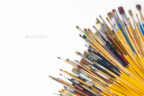 Many brushes for painting on a white background, top view. Stock Photo by  puhimec