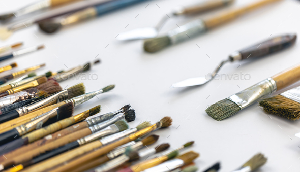 Many brushes for painting on a white background, top view. Stock Photo by  puhimec