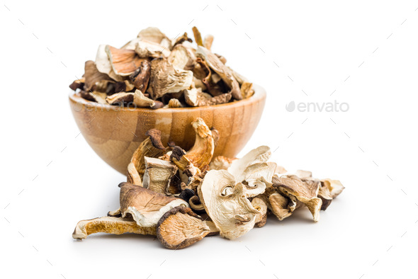Various sliced dried mushrooms in bowl isolated on white background. - Stock Photo - Images