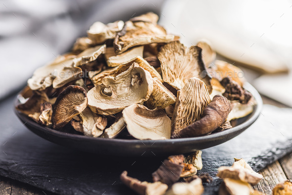 Various sliced dried mushrooms on plate. - Stock Photo - Images