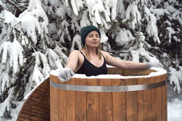 Caucasian woman during the winter bath in tube outdoors - Stock Photo - Images