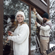 Caucasian couple decorating home for Christmas in lights - PhotoDune Item for Sale