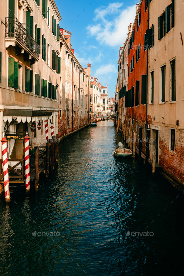 Characteristic canal of Venice with blue sky with clouds - Stock Photo - Images