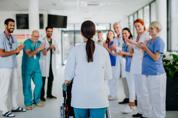 Medical staff clapping to senior patient who recovered from serious ...