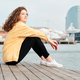 Relaxed woman looking away while sitting on promenade. - PhotoDune Item for Sale