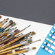 Brushes for drawing and paint on paper colored background, flat lay. - PhotoDune Item for Sale