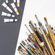 Brushes for drawing and paint on paper colored background, flat lay. - PhotoDune Item for Sale