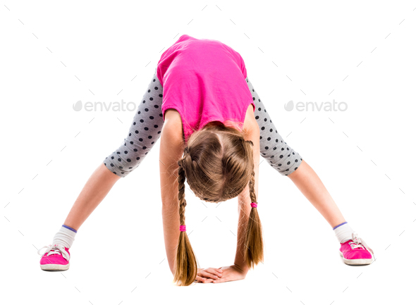 Foto de Little girl stretching. do Stock