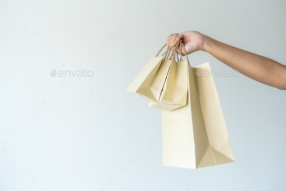 Woman carrying paper bag concept of reuse, recycle the object to zero waste.