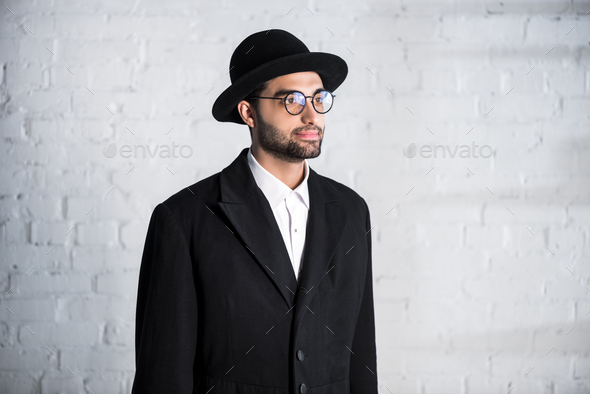 handsome jewish man in glasses and hat looking away - Stock Photo - Images