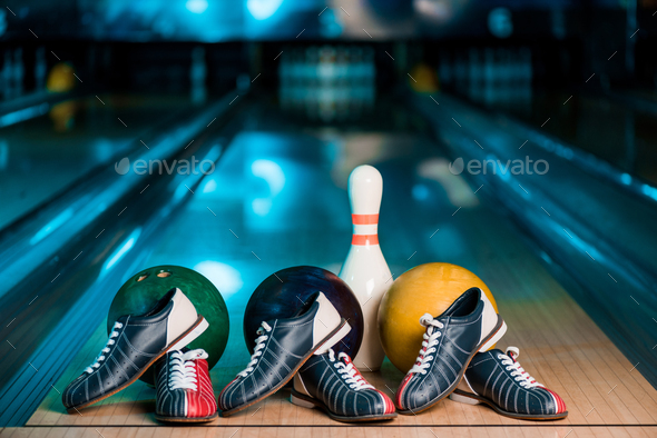 selective focus of bowling shoes, balls and skittle on skittle