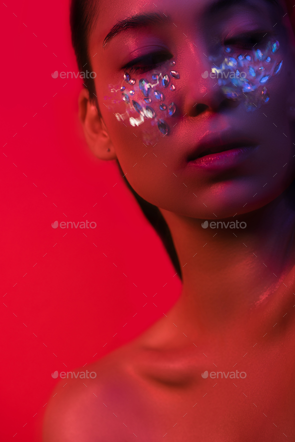 Beautiful Naked Asian Girl With Rhinestones On Face Isolated On Red Motion Blur Stock Photo By