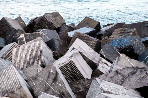 Large granite blocks prevent waves from invading inland due to rising sea levels.
