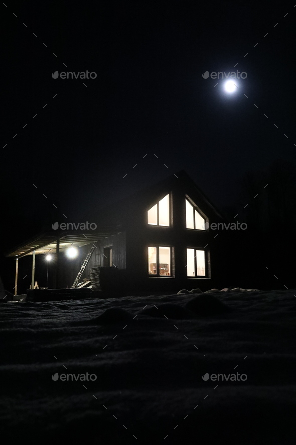 Landscape with house at night under dark sky with full moon. Spooky landscape with house in night.