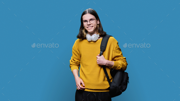 Portrait of university student guy on blue studio background - Stock Photo - Images