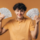 Rich excited man with cash money - USD currency dollars banknotes on yellow wall.  - PhotoDune Item for Sale