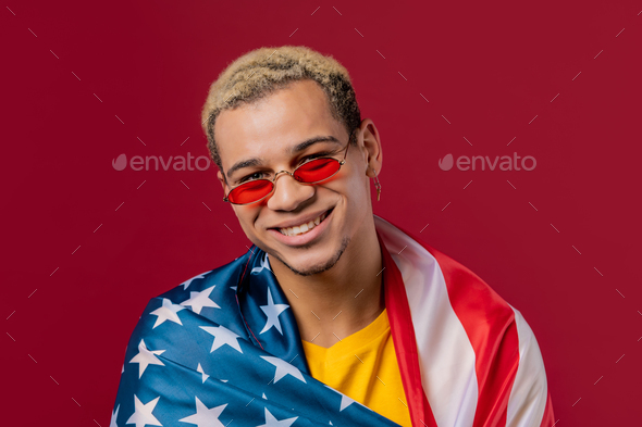Happy man with national USA flag on red background. American patriot, 4th of July - Independence day - Stock Photo - Images