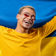 Smiling man with national Ukrainian flag. Ukraine, patriot, victory in war celebration, banner - PhotoDune Item for Sale