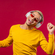 Positive american man listening music, enjoying dance with headphones on red studio background. - PhotoDune Item for Sale