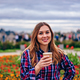 Beautiful young woman holding coffee cup and smiling - PhotoDune Item for Sale