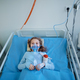 Close-up of little girl with infection disease lying in hospital room. - PhotoDune Item for Sale