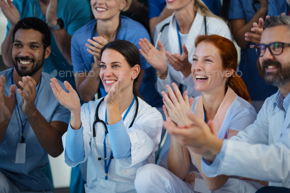 Portrait of happy doctors, nurses and other medical staff clapping in hospital. - Stock Photo - Images