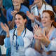 Portrait of happy doctors, nurses and other medical staff clapping in hospital. - PhotoDune Item for Sale