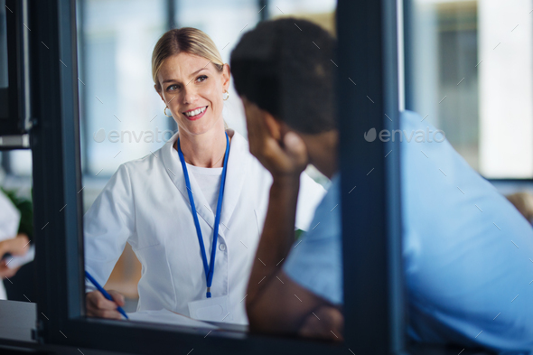 Medical stuff, colleagues talking, discussing at hospital corridor. Health care concept. - Stock Photo - Images