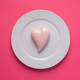 Pink heart on a plate on pink background. Simple concept for Valentine&#39;s day holiday - PhotoDune Item for Sale