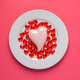 Pink and red hearts on a plate on pink background. Simple concept for Valentine&#39;s day holiday - PhotoDune Item for Sale
