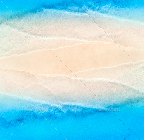 Aerial view of blue sea on the both sides empty sandy beach - Stock Photo - Images