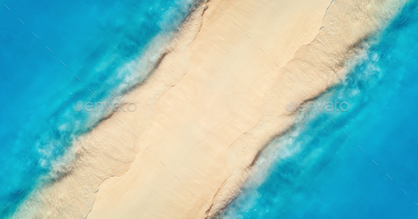 Aerial view of blue sea on the both sides empty sandy beach - Stock Photo - Images