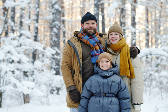 Family with child walking in forest - Stock Photo - Images