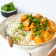 Traditional Indian dish chicken curry with basmati rice and fresh cilantro on rustic white plate on - PhotoDune Item for Sale