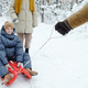 Parents sledding their child outdoors - PhotoDune Item for Sale