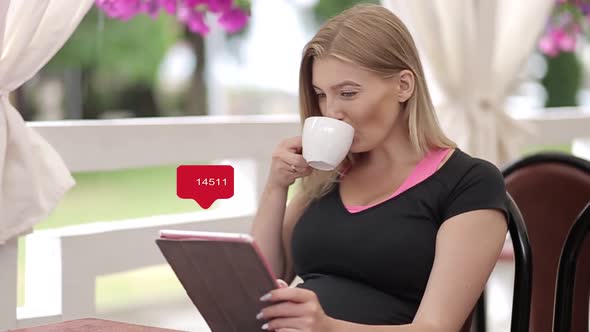 Counter of hearts in social networks, a woman gets likes using a tablet for a social network alt