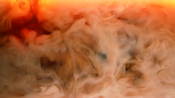 Cream is Poured Into a Hot Cup of Coffee Forming Swirling White Clouds alt