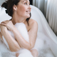 Self loving adult smiling woman with brunette hair taking bath with foam at home - PhotoDune Item for Sale