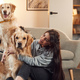 Modern interior. Woman is with two golden retriever dogs at home - PhotoDune Item for Sale