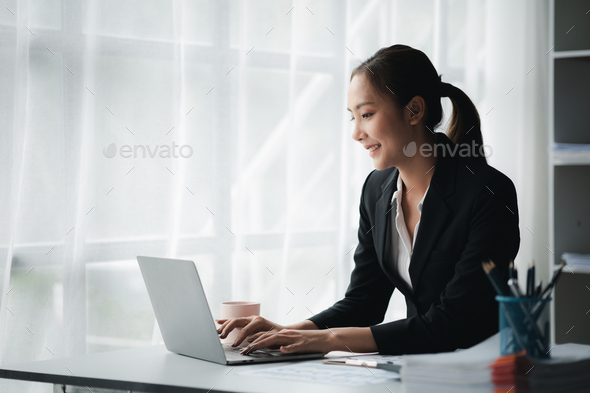 A businesswoman is checking company financial documents.