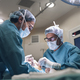 surgeons in medical masks operating patient in operating room - PhotoDune Item for Sale