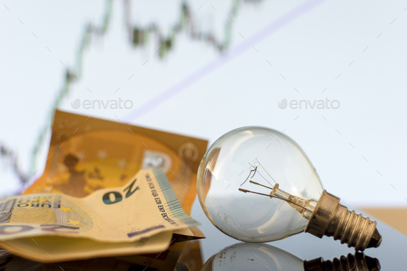 Bulb with euro banknotes beside it. Increase in energy tariffs. Efficiency and energy saving. - Stock Photo - Images