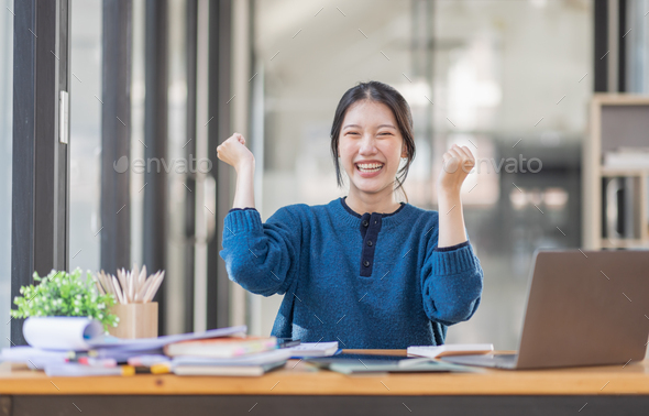 Image of a happy excited young entrepreneur Asian woman in workplace ...