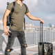 Portrait of a traveller man holding a smartphone and a carrying suitcase - PhotoDune Item for Sale