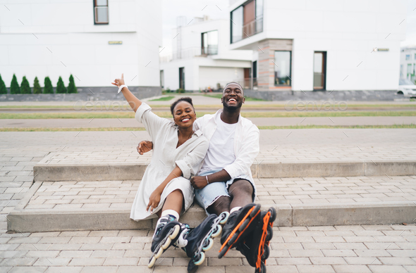 Happy Black Couple Hugging On Stairs And Smiling At Camera Stock Photo 