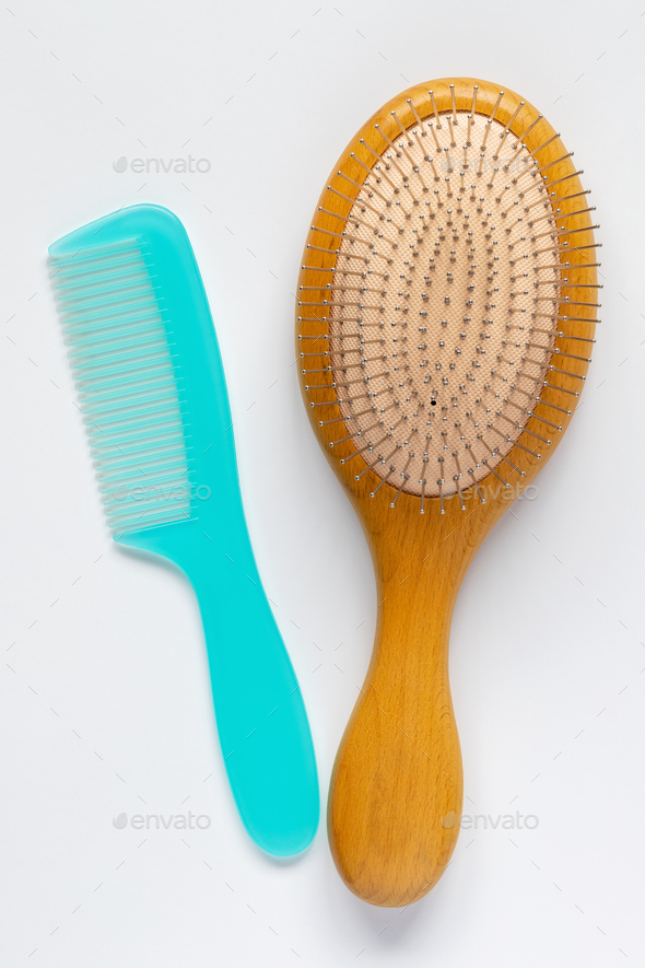 Hair brush and comb on white background.