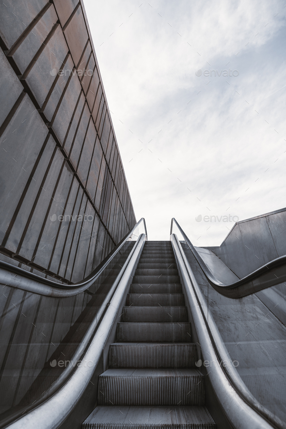 Outdoor city escalator with the wall on the left - Stock Photo - Images