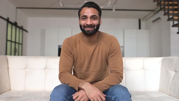 Smiling Friendly Young Bearded Indian Freelancer Guy Look and Talks at Camera alt